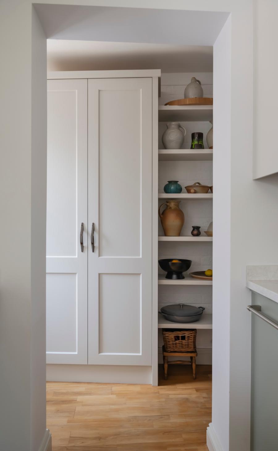 a simple utility cupboard with open shelving for a ceramics collection