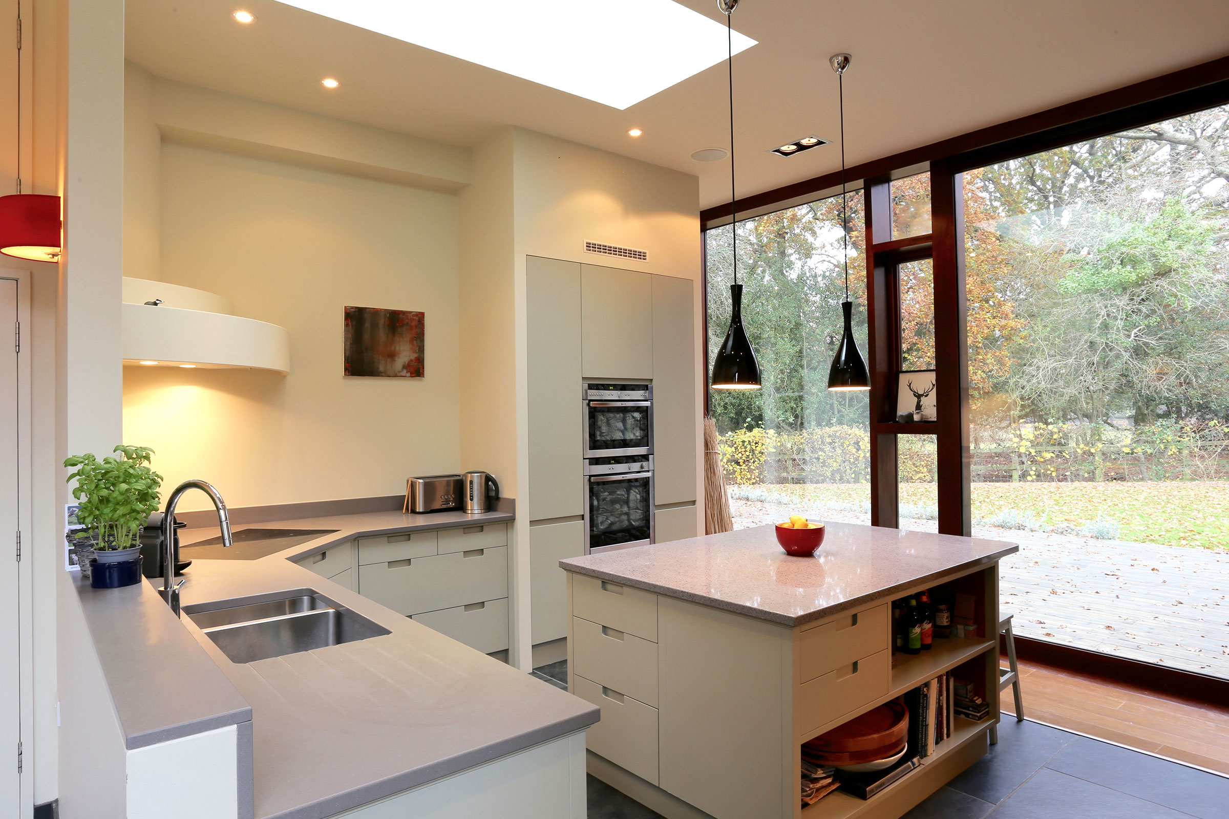 handless contemporary kitchen with flase wall work to house ovens