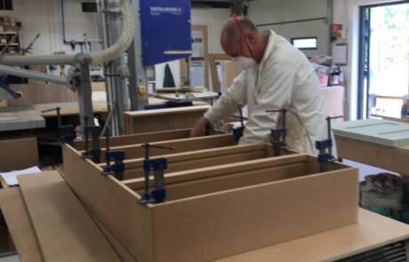Richard checking bookshelves being made in our workshop