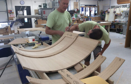 curved doors being checked after being made in our vacuum press